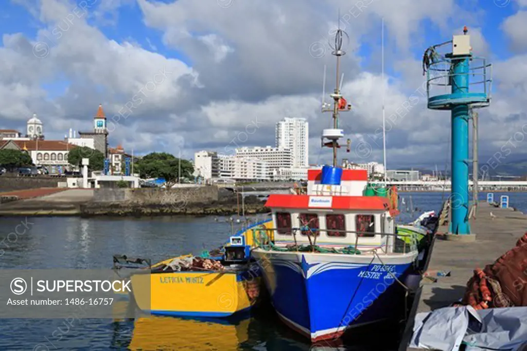 Fishing boats at a port with city in the background, Ponta Delgada, Sao Miguel, Azores, Portugal