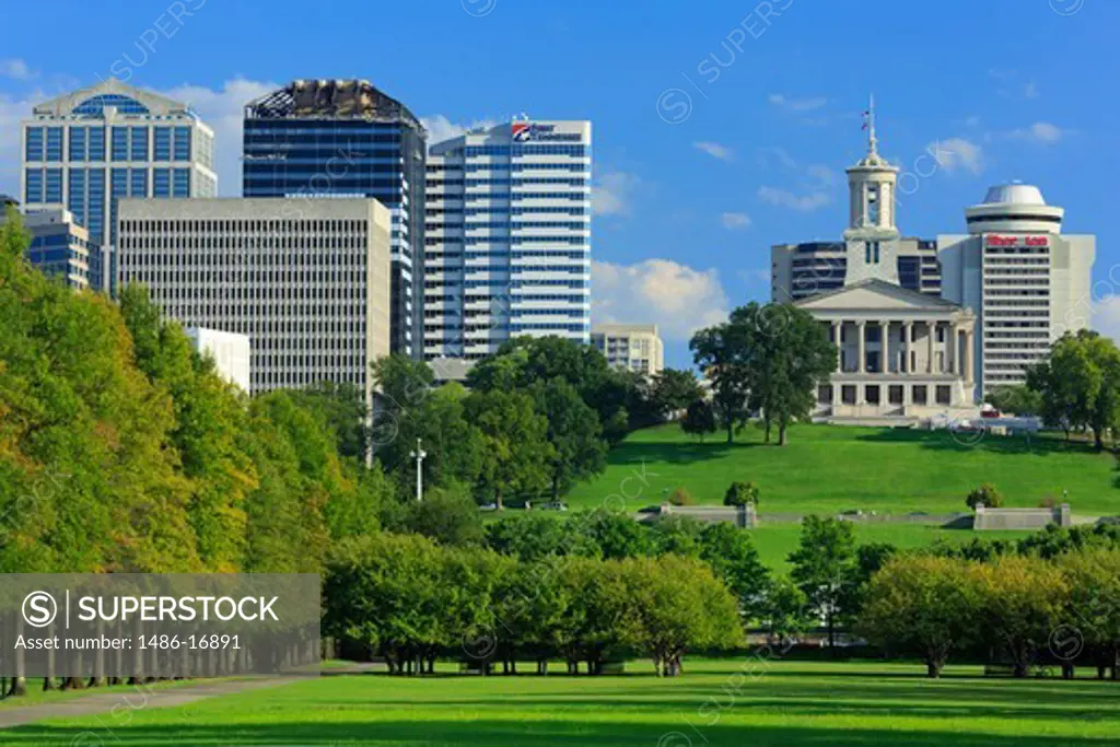 Trees in a park with buildings in the background, Bicentennial Capitol Mall State Park, Capitol Building, Nashville, Tennessee, USA