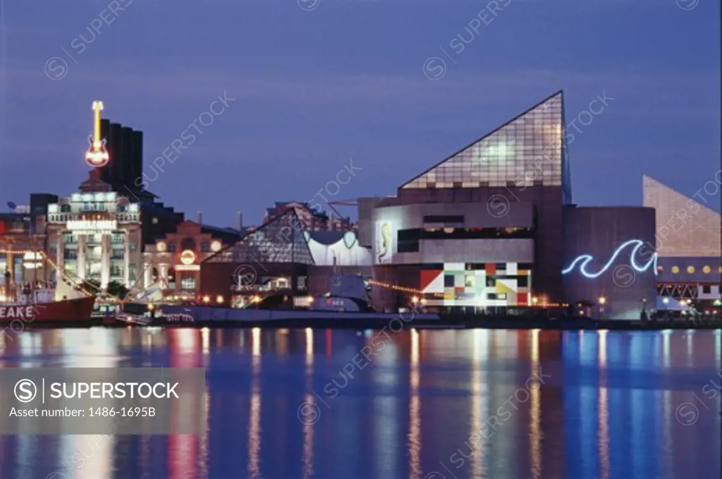 Buildings on the waterfront lit up at dusk, National Aquarium, Baltimore, Maryland, USA