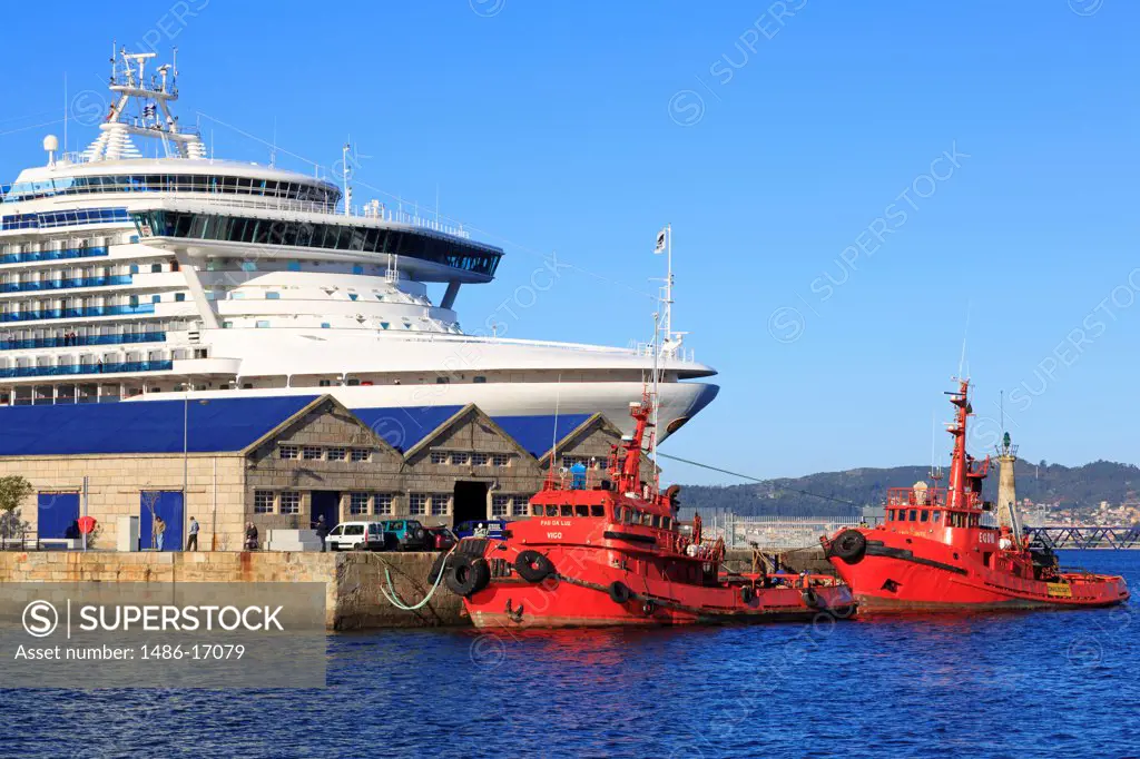 Tugboats and cruise ship at the port of Vigo, Galicia, Spain