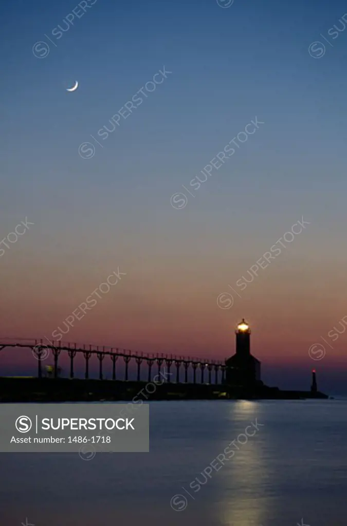 Lighthouse lit up at dusk, Michigan City East Pier Lighthouse, Lake Michigan, Michigan City, Indiana, USA