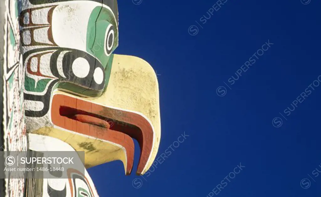 Canada, British Columbia, Vancouver, Stanley Park, totem pole against blue sky