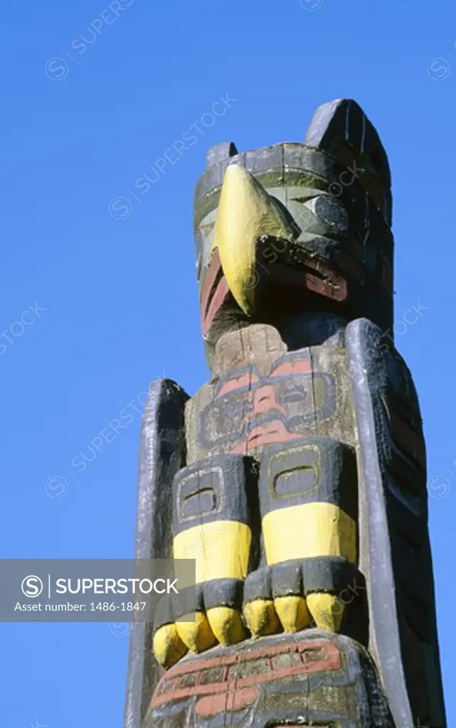 Canada, British Columbia, Vancouver, Stanley Park, Totem Pole against blue sky