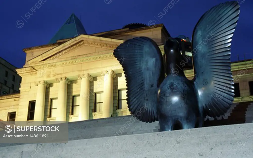 Canada, British Columbia, Vancouver, bronze statue of bird against neo-classical building
