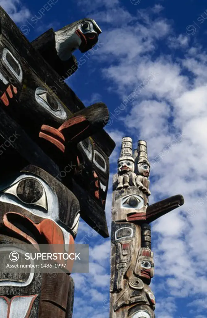 Canada, British Columbia, Victoria, Thunderbird Park, totems against sky, low angle view