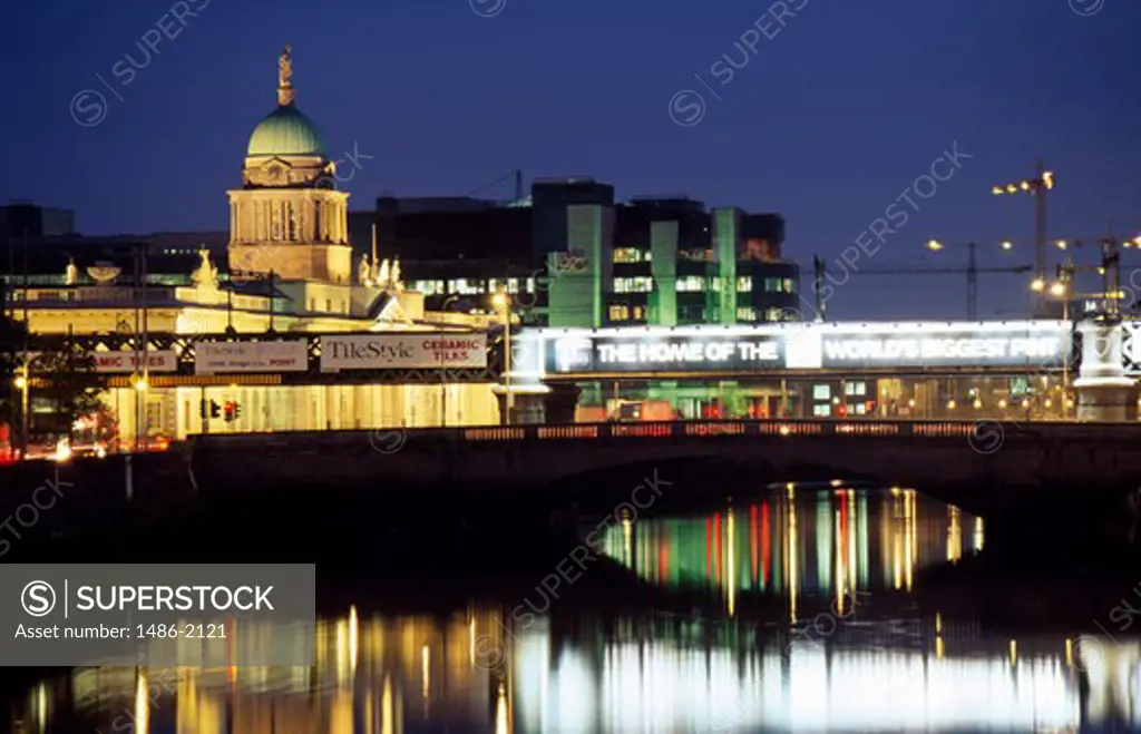 Reflection of a lit up government building in water at dusk, Custom House, Dublin, Ireland