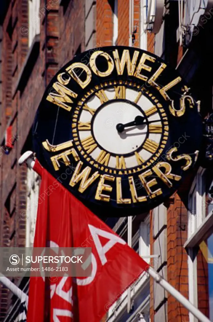Low angle view of a sign with a clock, Dublin, Ireland