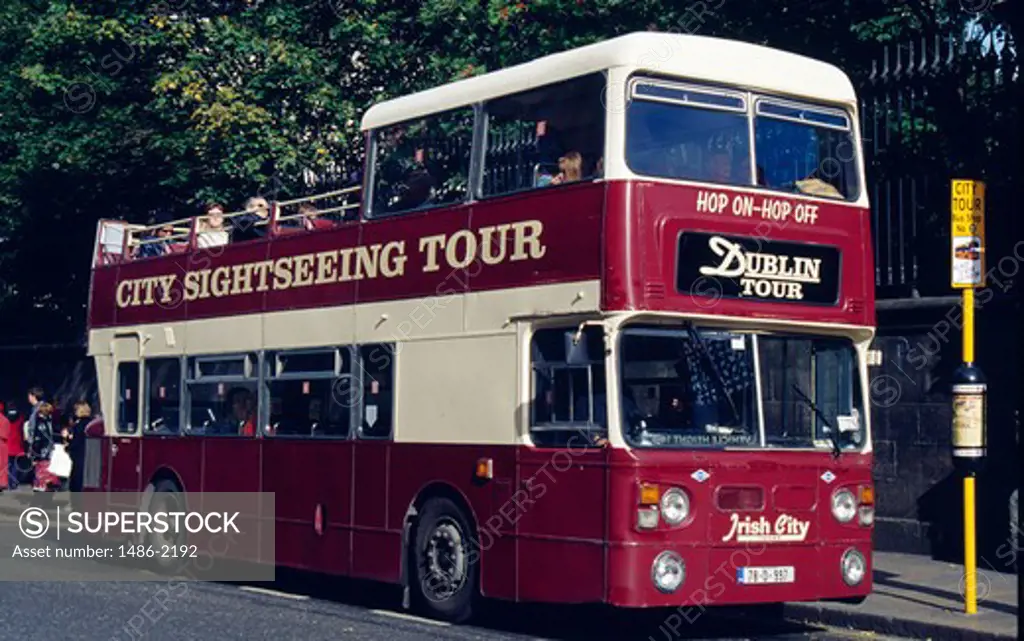Tourists traveling in a open-air double-decker Bus, Dublin, Ireland