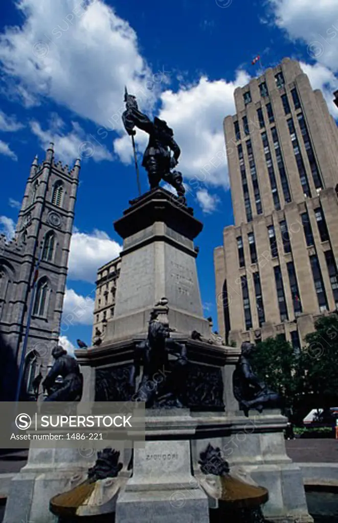 Paul Chomedey's statue with a church in the background, Notre Dame de Montreal, Place d'Armes, Montreal, Quebec, Canada