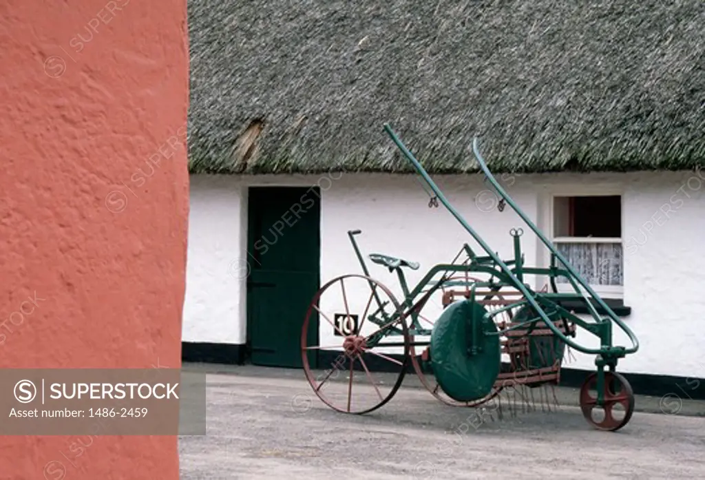 Old fashioned plough in front of a house, Bunratty Folk Park, County Clare, Ireland