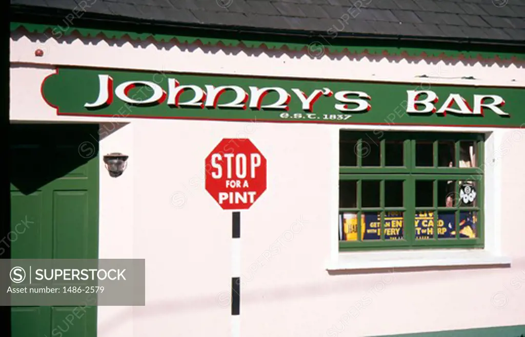 Stop sign in front of a bar, Fieries, County Kerry, Ireland