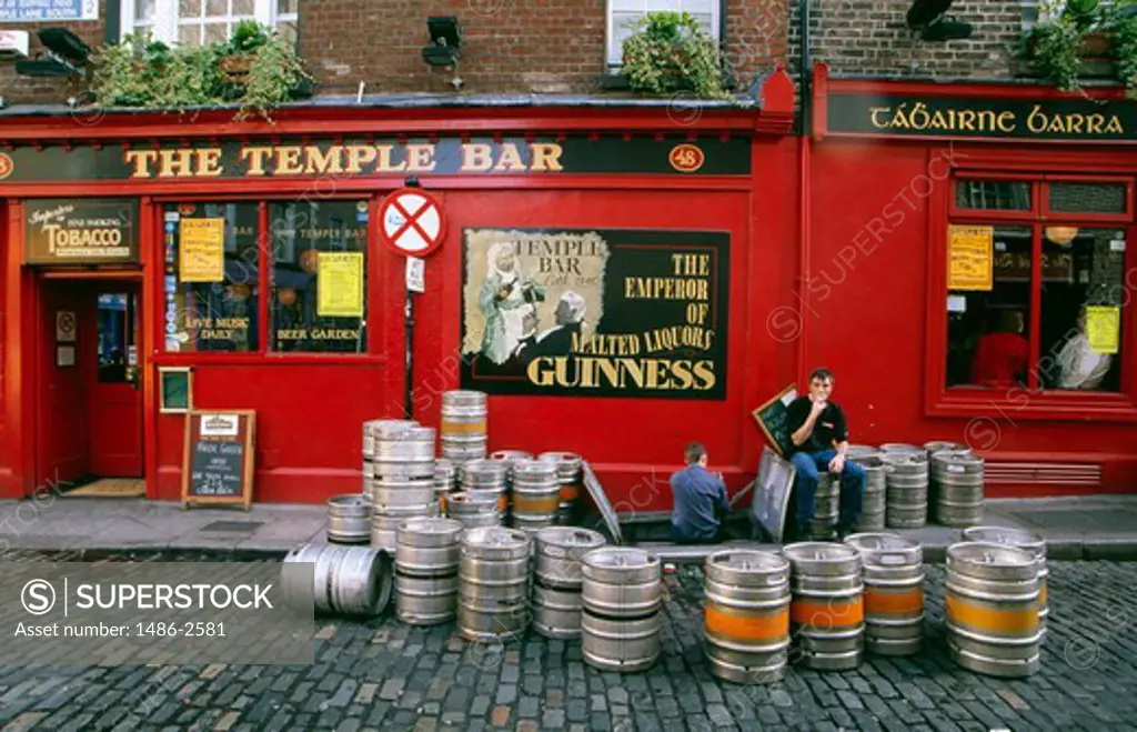 Two people sitting in front of a bar, Dublin, Ireland