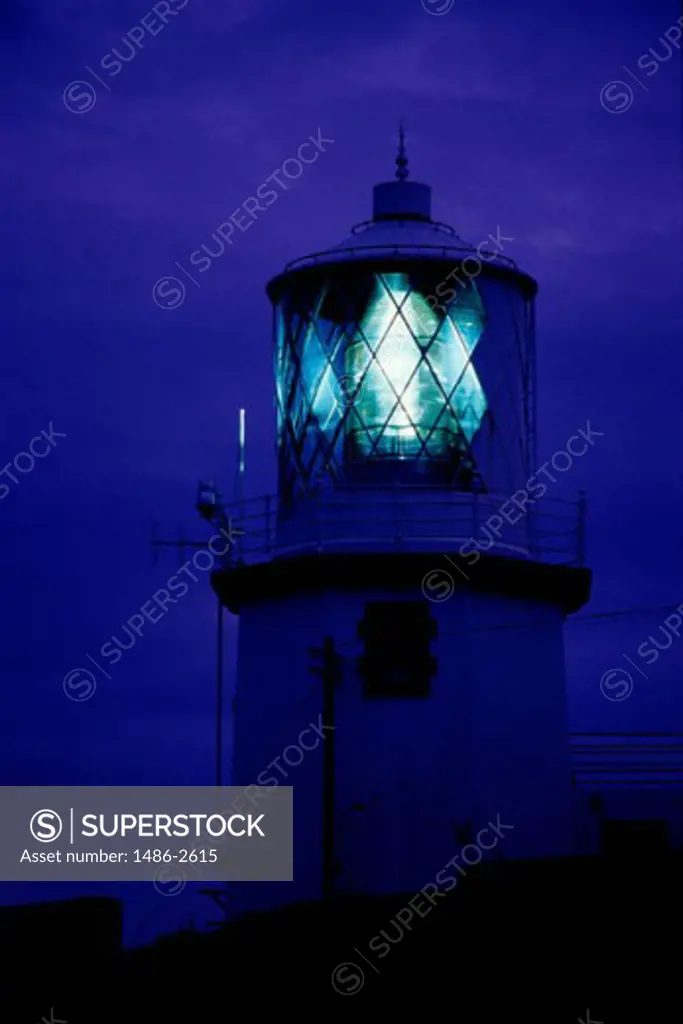 Low angle view of a lighthouse lit up at night, Blackhead Lighthouse, Island Magee, County Antrim, Northern Ireland