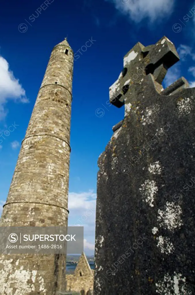 Low angle view of a tombstone and a tower, Round Tower, Ardmore, Ireland
