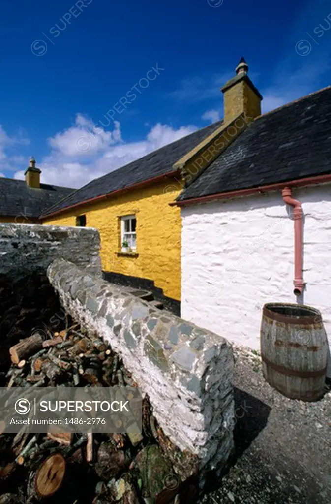 Wooden logs beside a stone wall, Killarney, County Kerry, Ireland