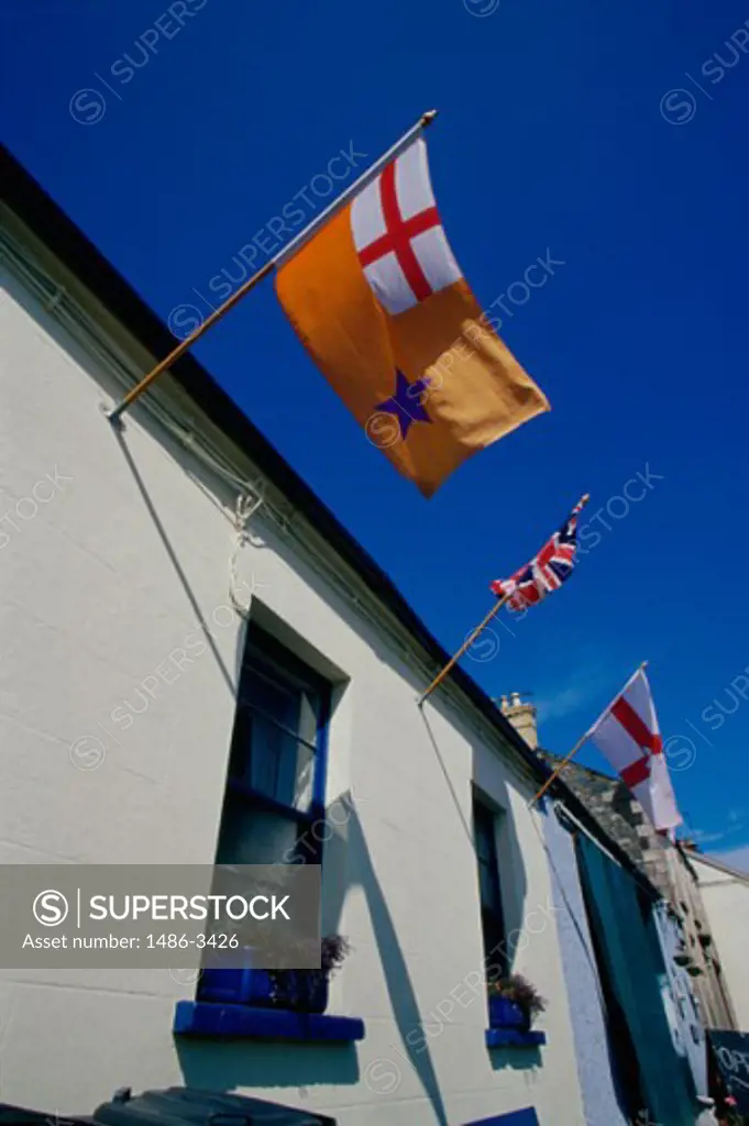 Low angle view of flags hanging on a building, Greyabbey, County Down, Northern Ireland