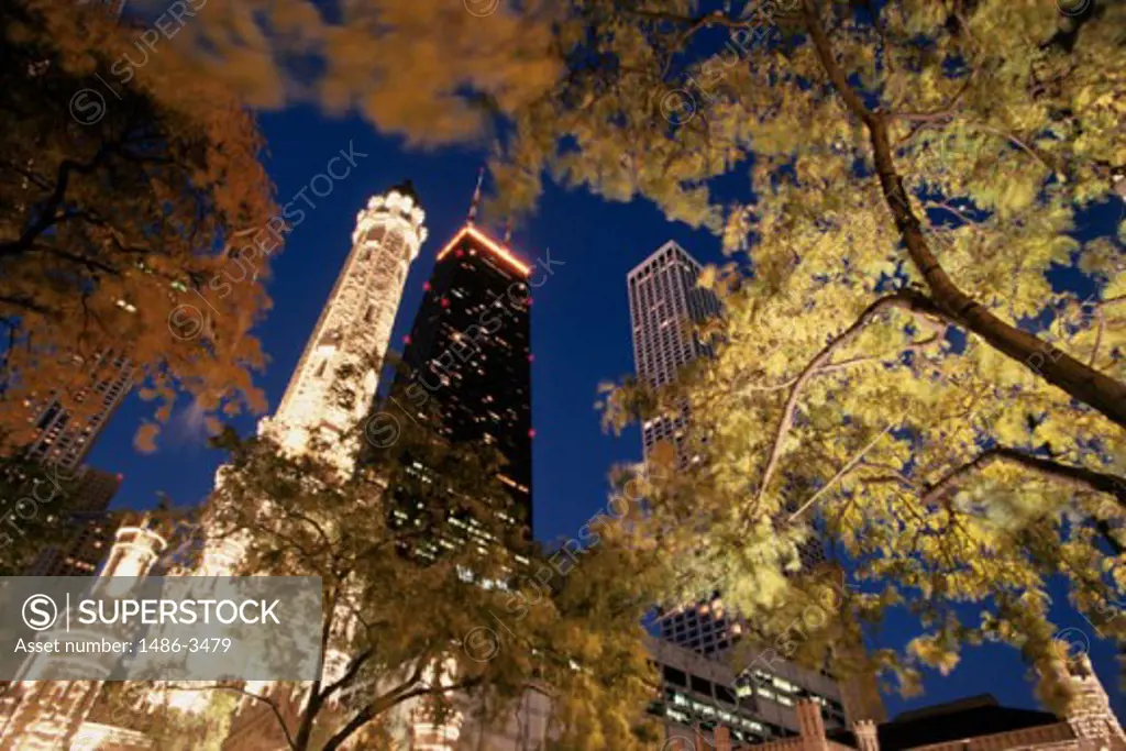 Low angle view of buildings lit up at night, Old Water Tower, John Hancock Tower, Chicago, Illinois, USA