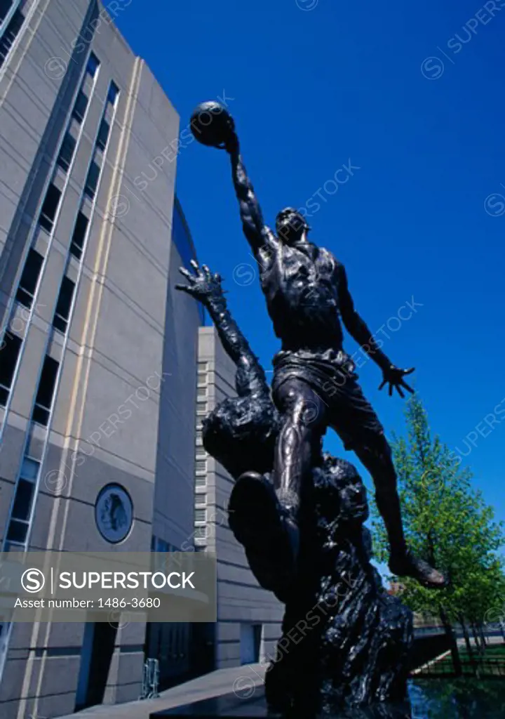 Low angle view of a statue in front of a building, Michael Jordan Statue, United Center, Chicago, Illinois, USA