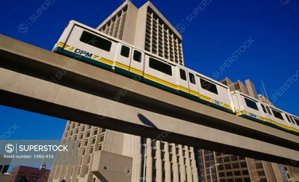 Low angle view of a passenger train on an elevated railway track, Federal Building, Detroit, Michigan, USA