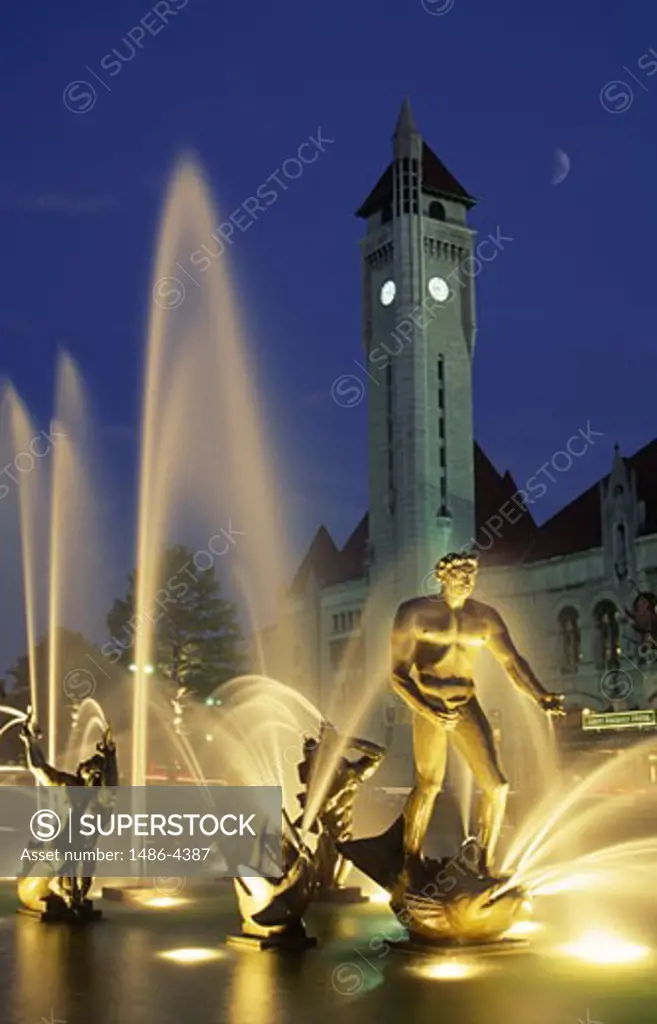 USA, Missouri, St. Louis, illuminated Waters Fountain with clock tower behind
