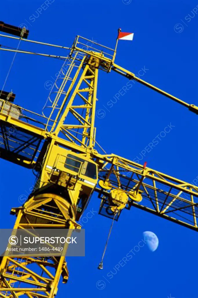 Low angle view of a flag on top of a crane