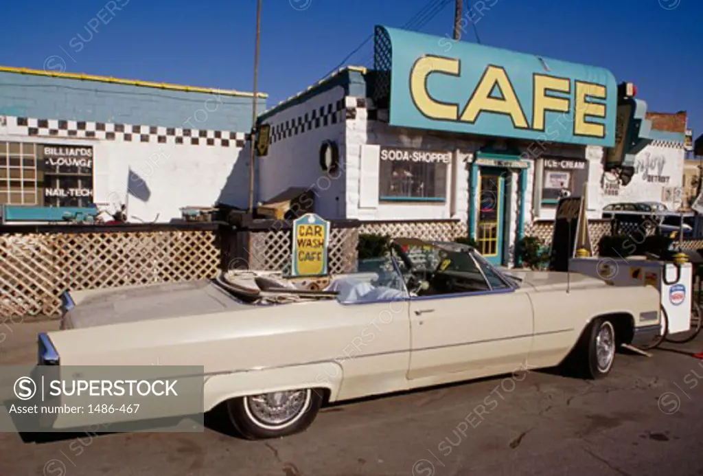 Car parked in front of an auto repair shop, ClassicVille Car Wash and Cafe, Detroit, Michigan, USA