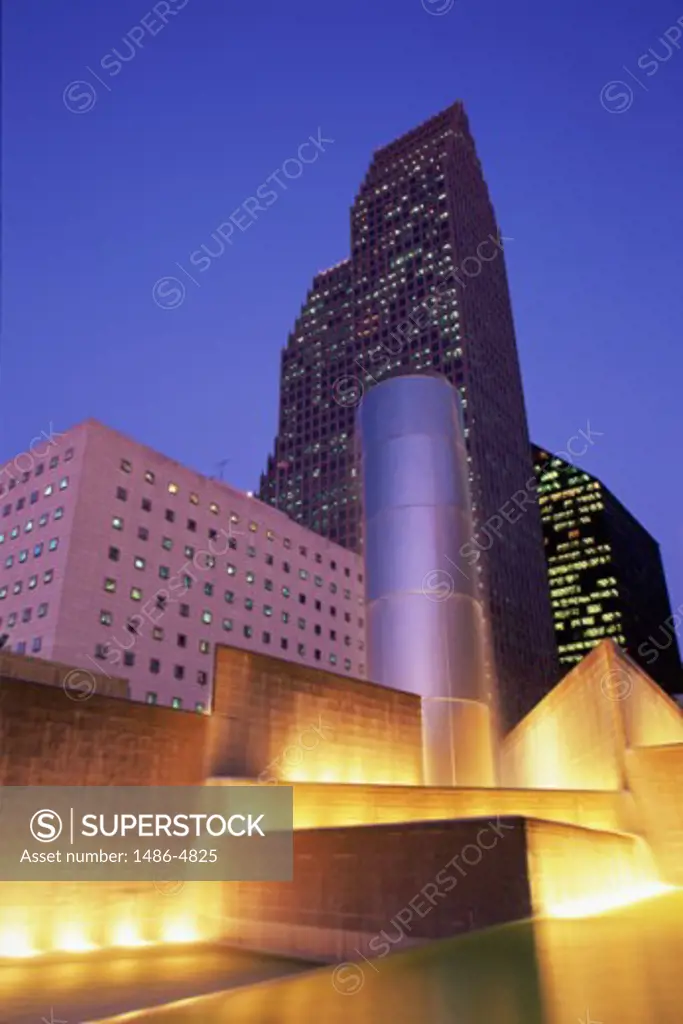 Low angle view of skyscrapers in a city lit up at night, Tranquility Park, Houston, Texas, USA