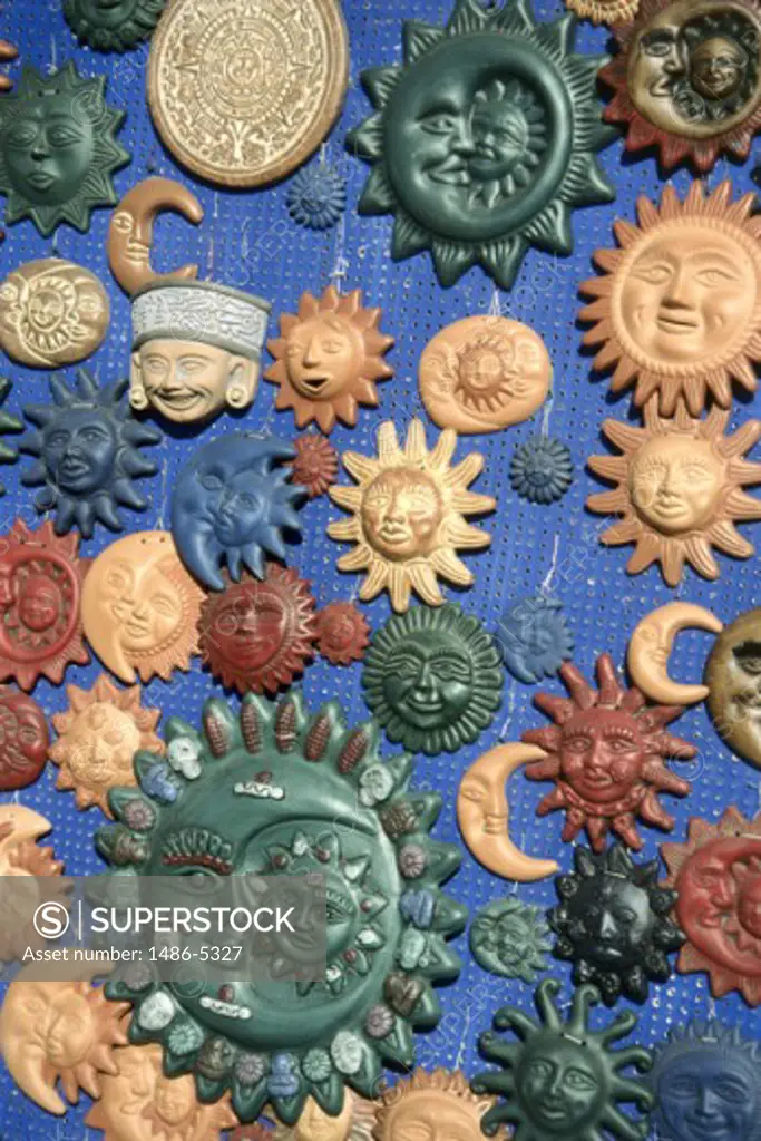 Close-up of anthropomorphic faces hanging on a pegboard, Tijuana, Mexico