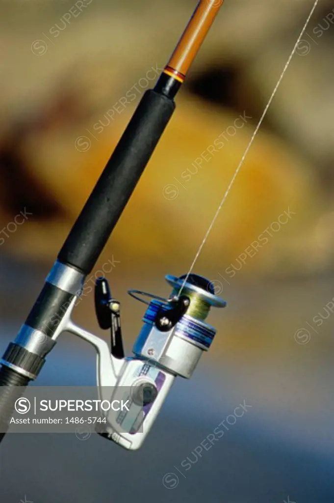 Close-up of a fishing reel on a fishing rod