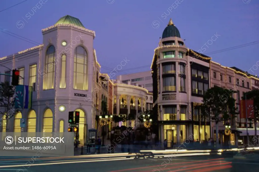 Stores along a road lit up at dusk, Beverly Hills, California, USA