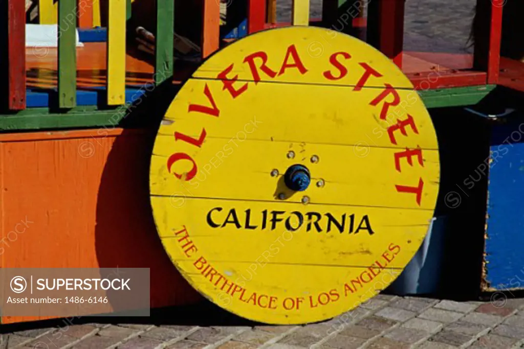 Wagon wheel as a sign board, Los Angeles, California, USA