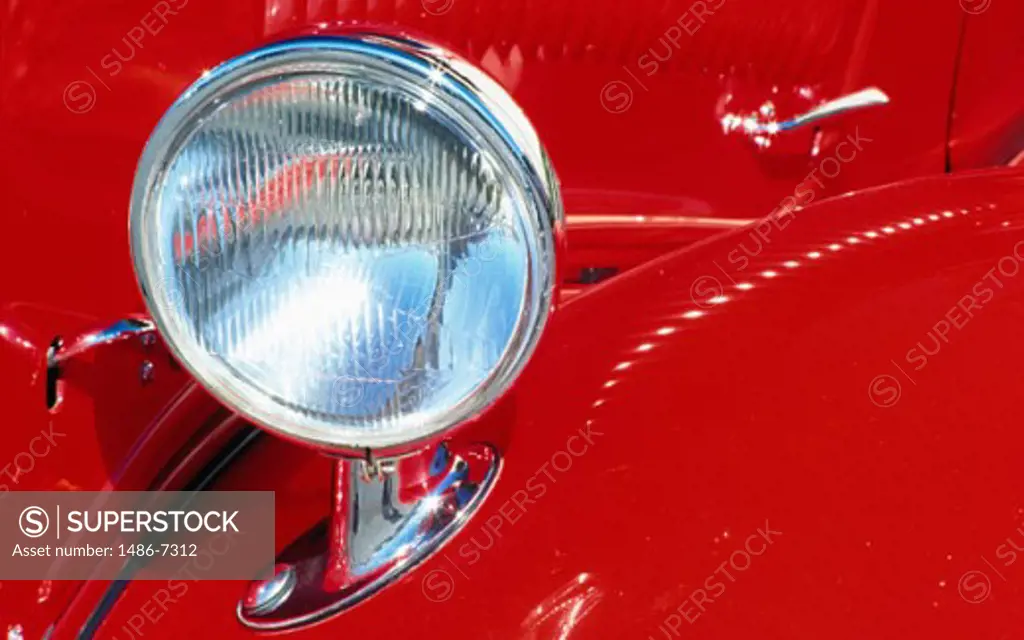 Close-up of the headlight of an antique car