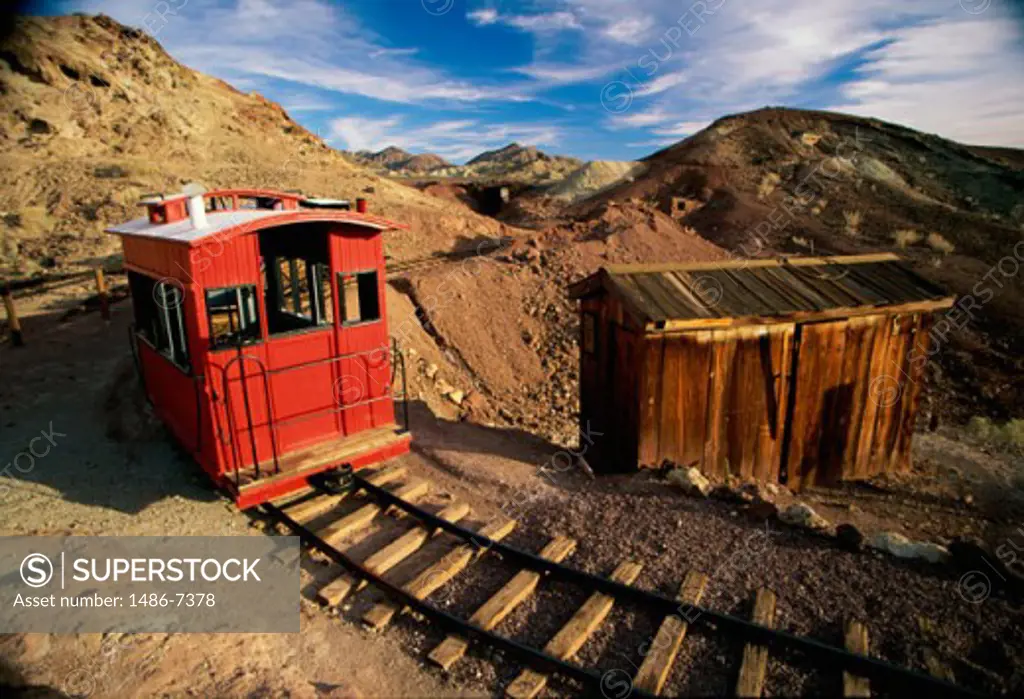 Train passing by an abandoned cabin, Calico Ghost Town, California, USA