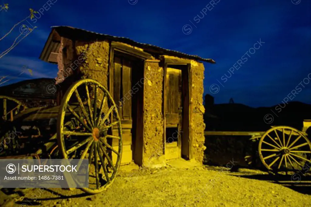 Wagon wheel outside an abandoned cabin, Calico Ghost Town, California, USA