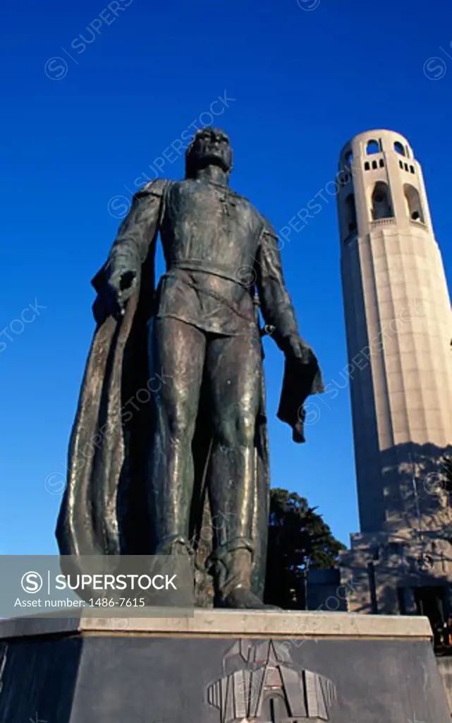 Statue of Christopher Columbus with a tower in the background, Coit Tower, San Francisco, California, USA