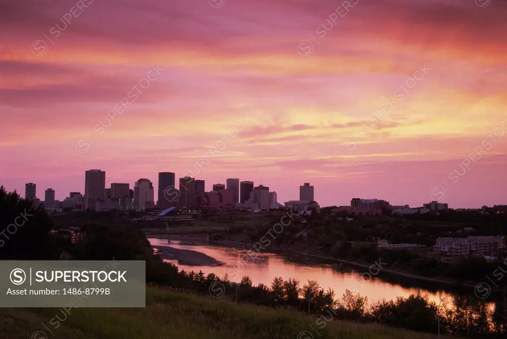 Silhouette of buildings across a river, Saskatchewan River, Edmonton, Alberta, Canada