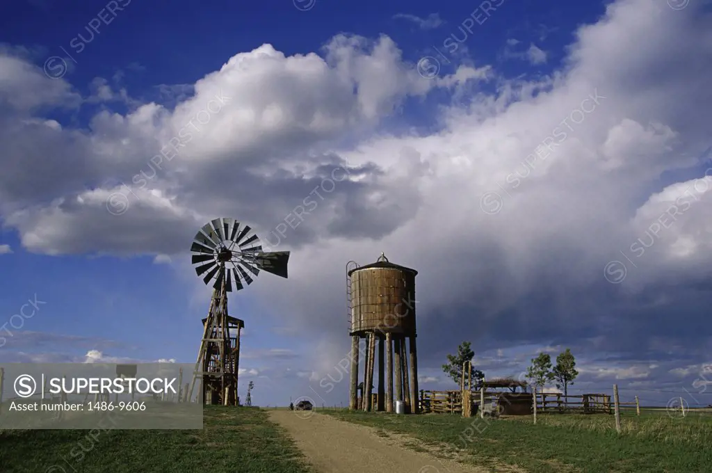 Low angle view of a water tower and an industrial windmill, 1880 Town, South Dakota, USA