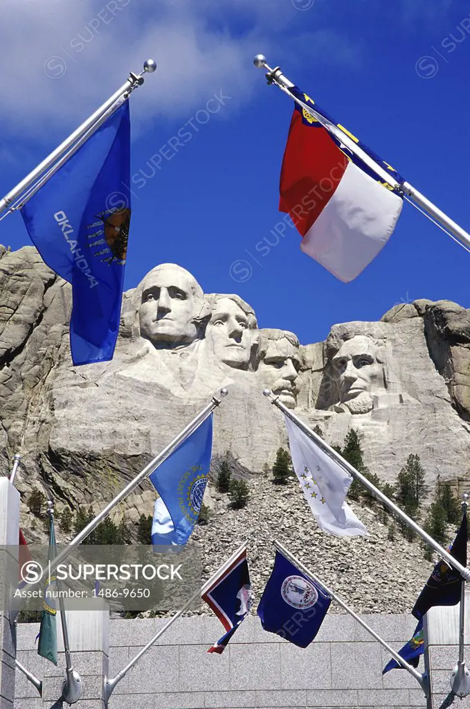 Low angle view of flags in front of Mount Rushmore National Memorial, South Dakota, USA