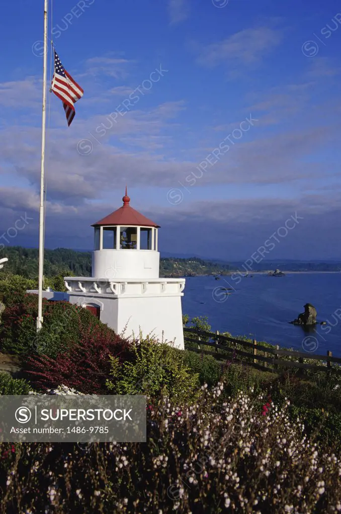 American flag fluttering near a lighthouse, Trinidad Memorial Lighthouse, Trinidad, California, USA