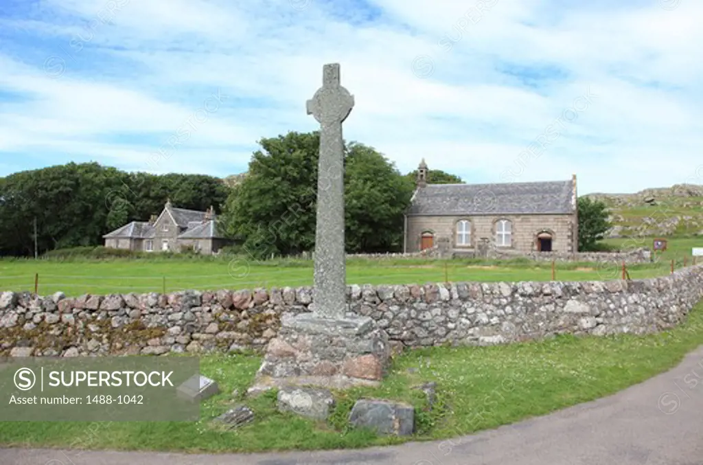 Stone cross with houses in the background, Iona, Inner Hebrides, Scotland