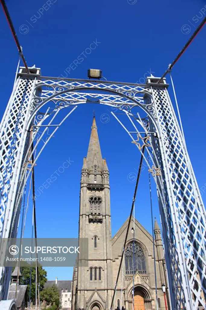 Suspension bridge with a church in the background, Infirmary Bridge, Inverness, Highlands Region, Scotland