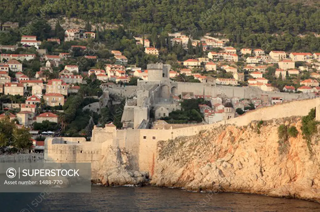 City wall with houses at the waterfront, Dubrovnik, Dalmatia, Croatia