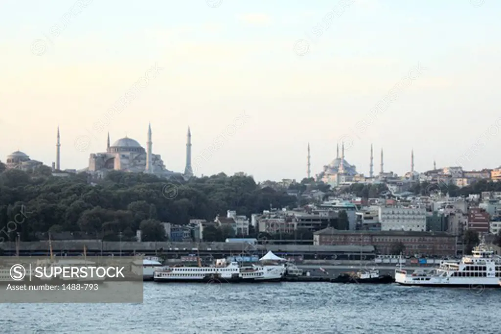 Early morning view of a harbor with the Blue Mosque and Hagia Sophia in the background, Istanbul, Turkey