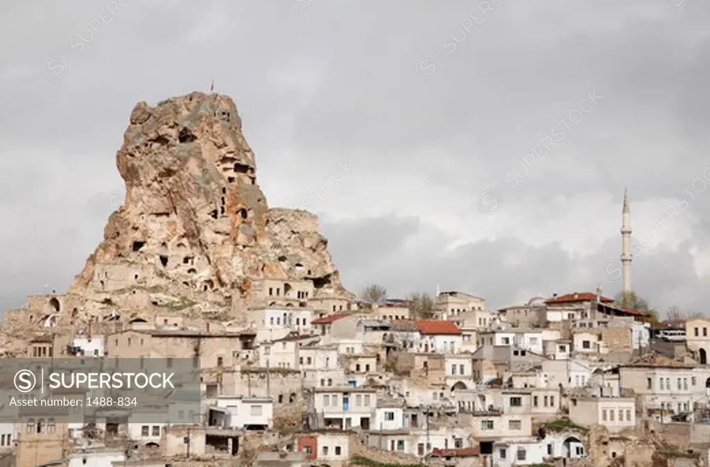 Town with cave houses in the background, Goreme, Cappadocia, Central Anatolia, Turkey