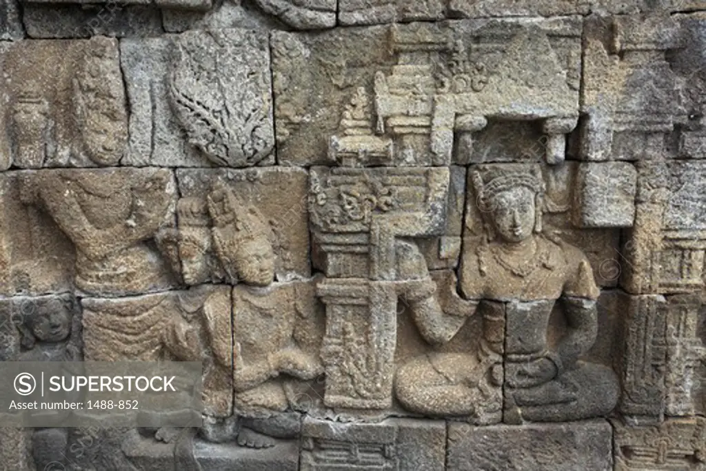 Statues carved on the wall of a temple, Borobudur Temple, Java, Indonesia