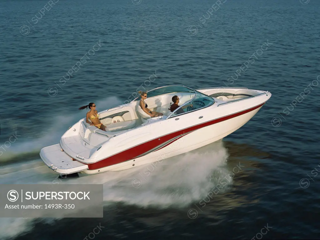 Three people in a motorboat