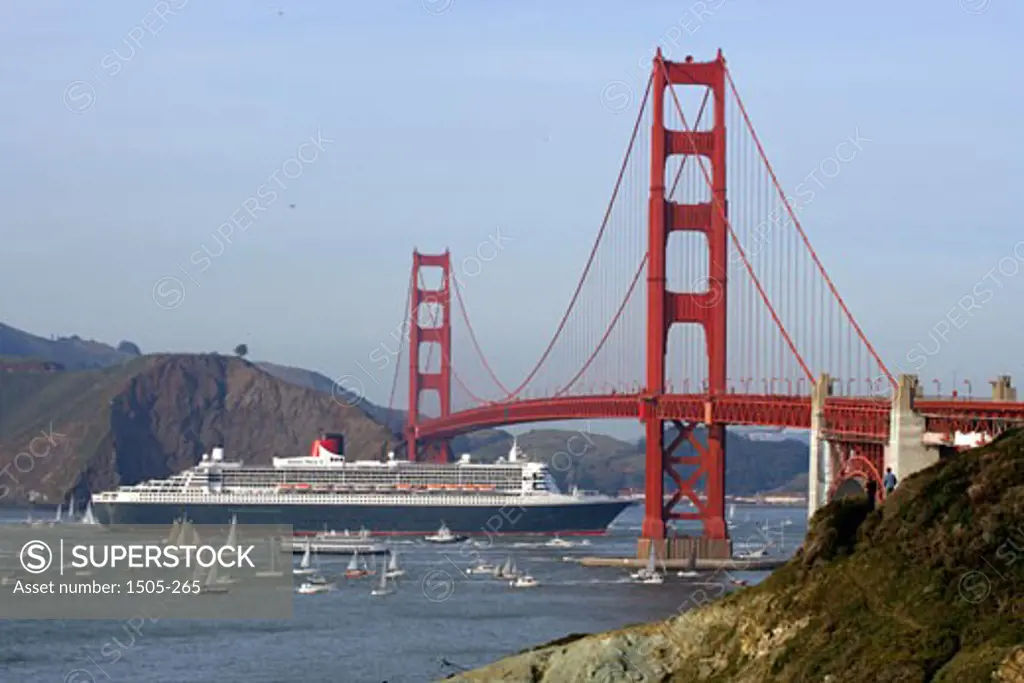 Cruise ship passing under a bridge, RMS Queen Mary 2, Golden Gate Bridge, San Francisco, California, USA