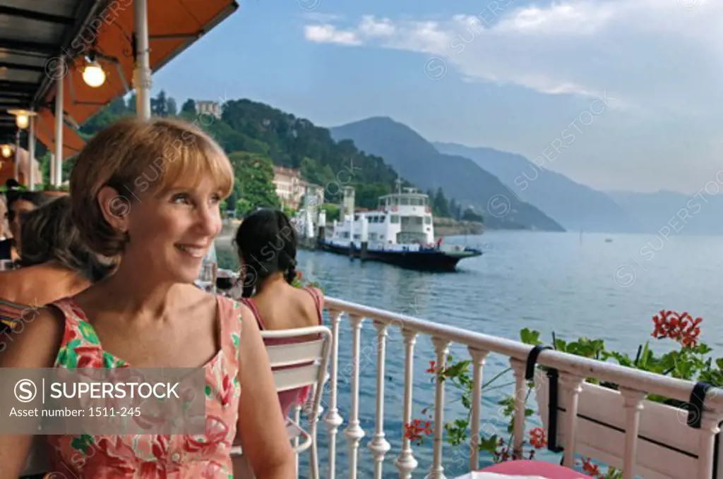 Young woman sitting in a restaurant, Lake Como, Bellagio, Italy