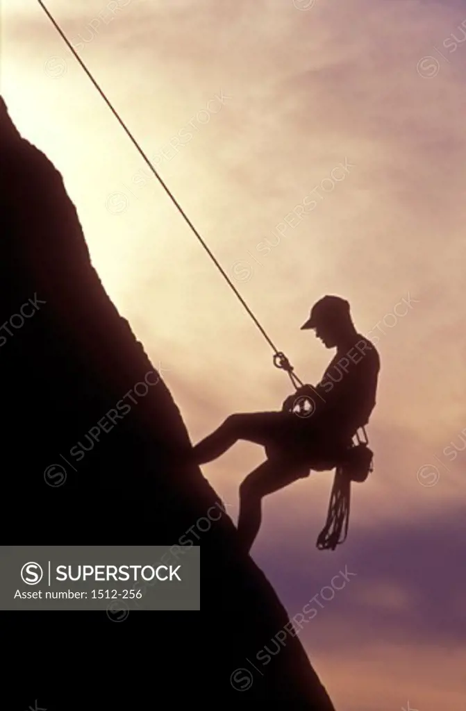 Side profile of a man climbing a mountain, Malibu, California, USA