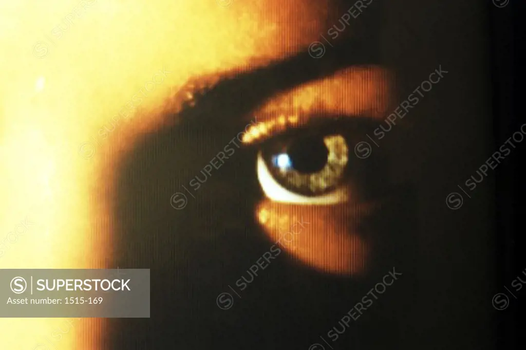 Close-up of a human eye on a television screen